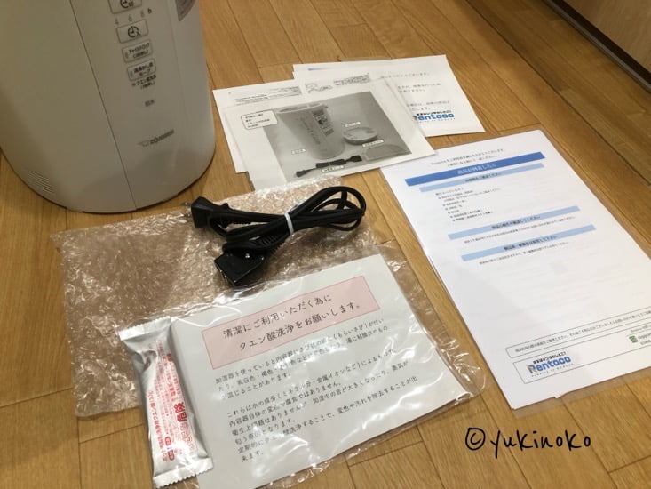 加湿器と付属品を床に並べている様子